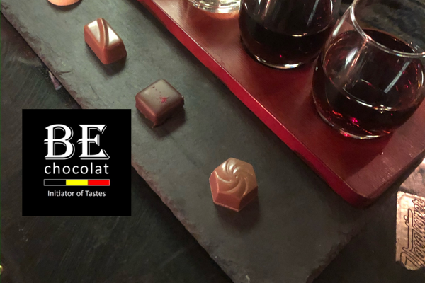 Nebbiolo wine paired with Belgian chocolate on a dark brown table made out of wood